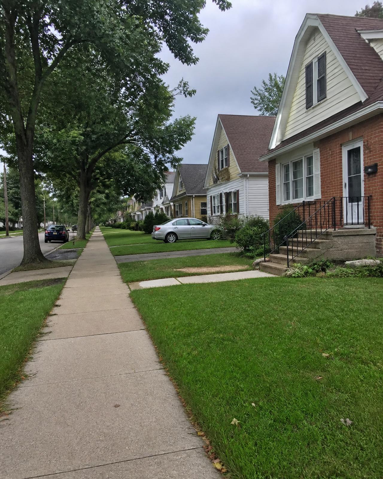 A quiet residential street of older lived-in homes